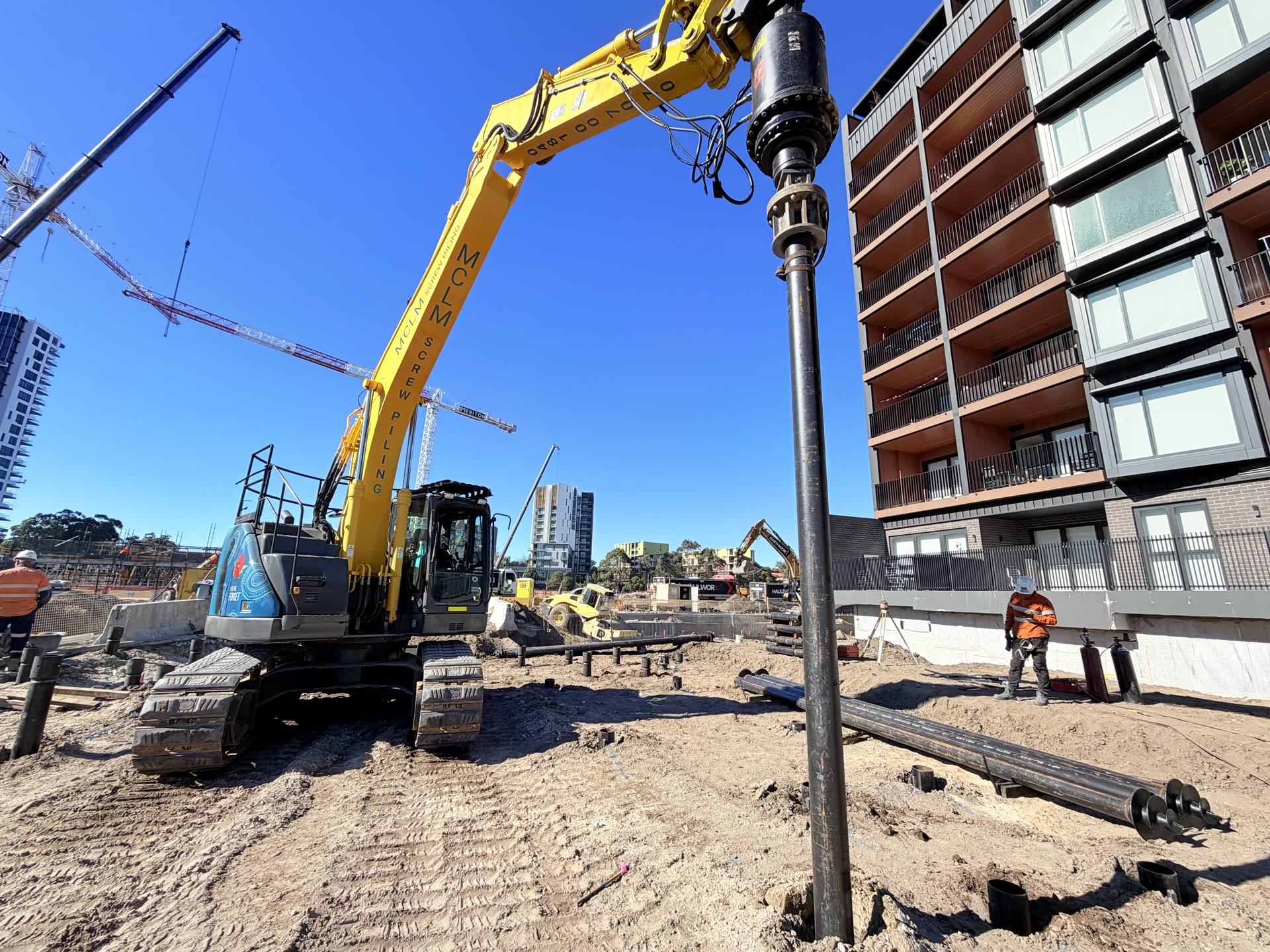 Screw piles installed across an active construction site
