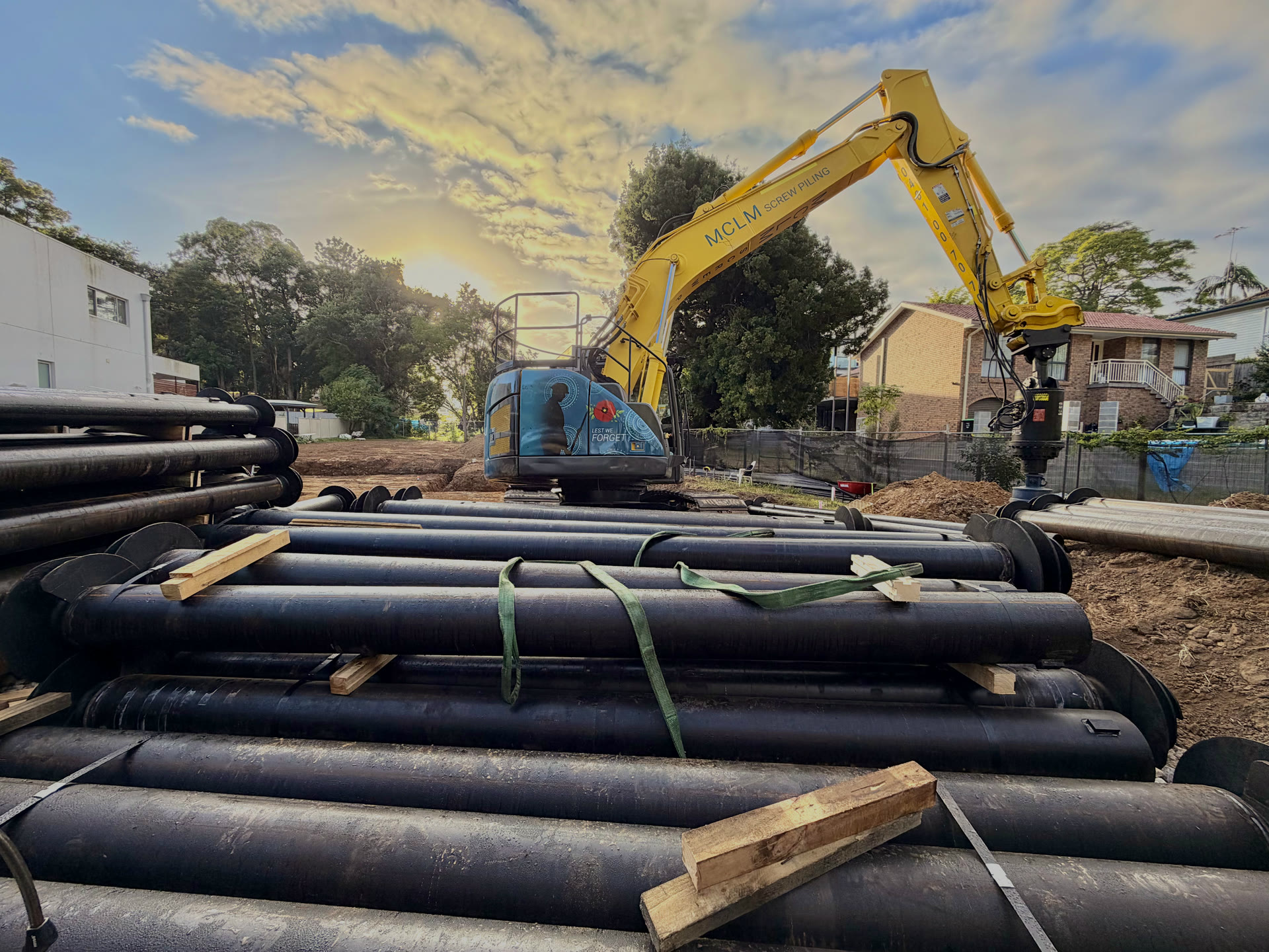 Screw piles stored in steel cages ready for reuse