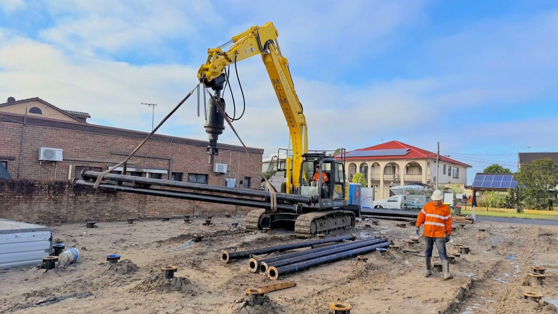 Screw pile installation on a residential construction site